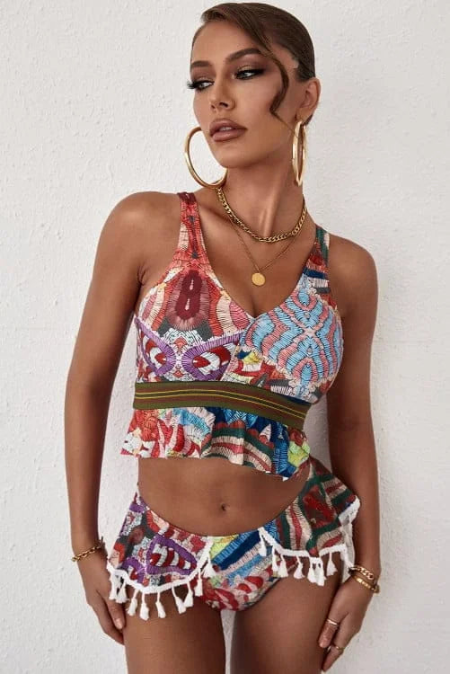 Woman wearing a colorful patterned outfit with a white background