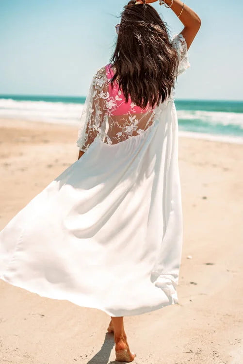 Woman in a white cover-up with pink bikini on a beach