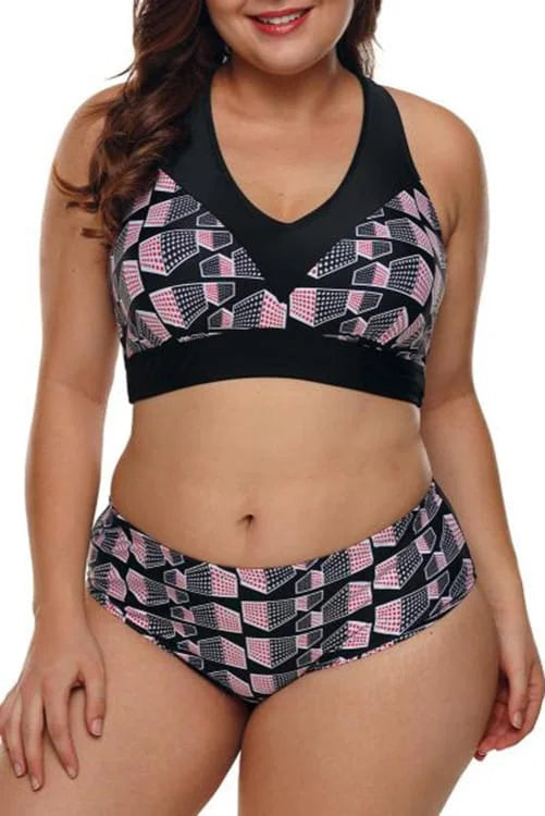 Woman wearing a black and pink patterned bikini set on a white background
